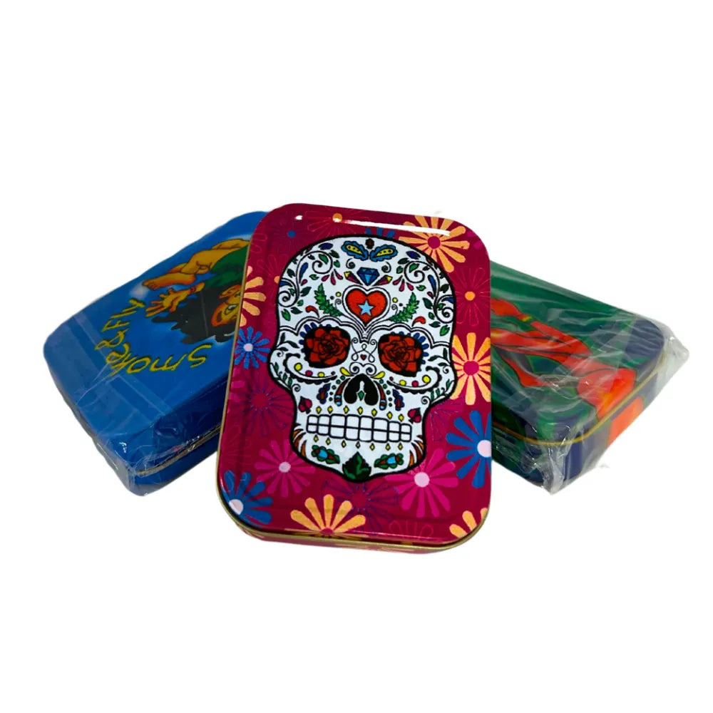 Three colourful storage baccy tins with a skull design on the front on a white background.