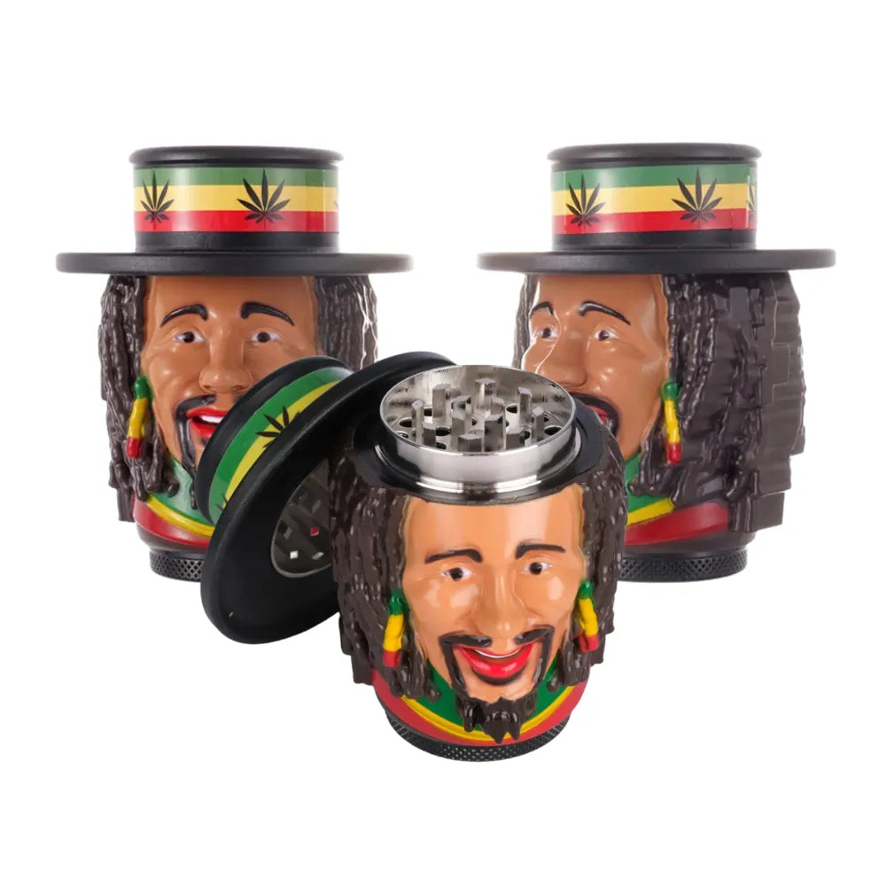 Three tobacco grinders with a face and hat design and Rastafarian colours on a white background