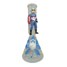 Figure of a superhero character on top of a grey glass waterpipe with colourful designs.