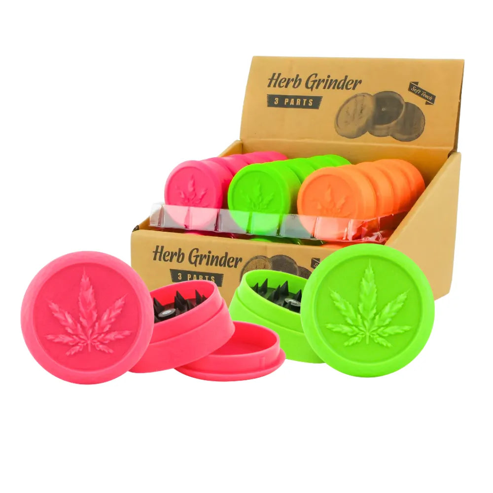 Soft touch plastic herb grinders in multiple vibrant colours with cannabis leaf design