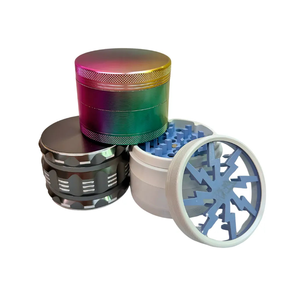 Multicoloured metal grinders and one with open top showing blue interior on a white background