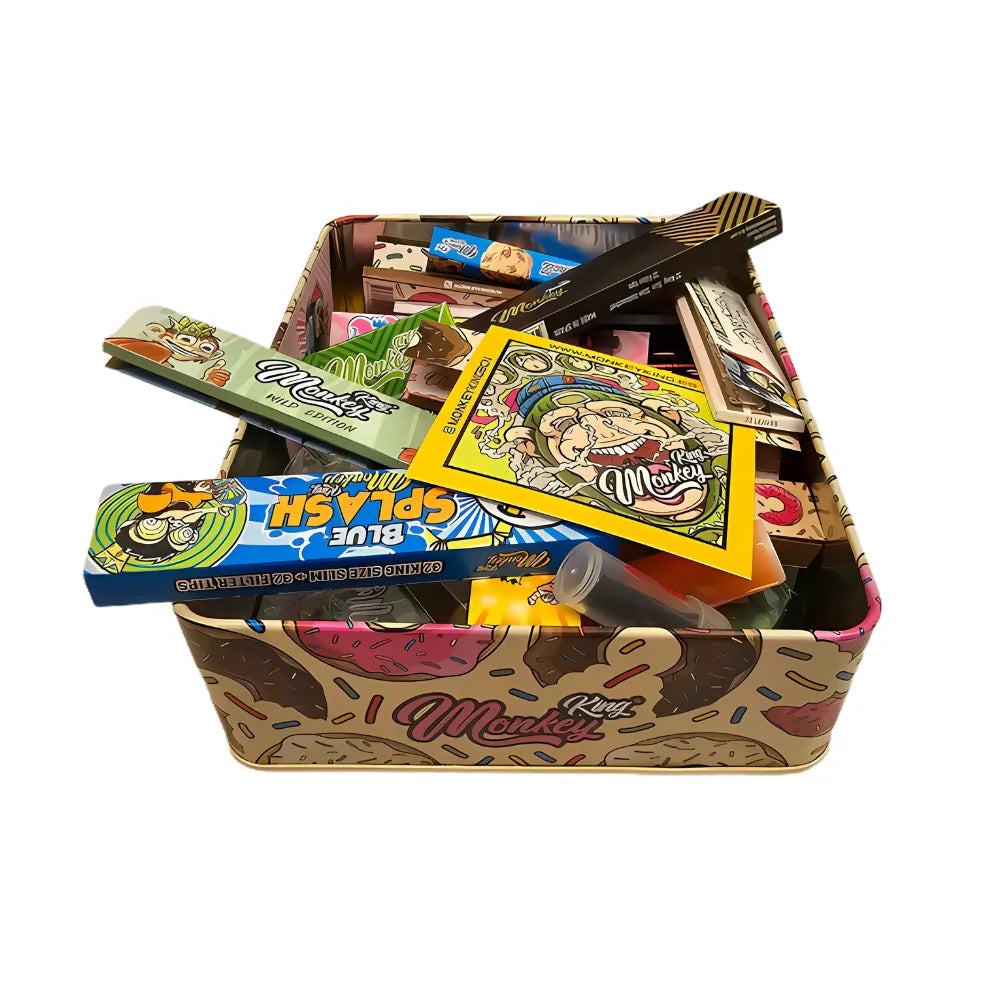 Colourful Monkey king smoking tin with various smoking accessories on a white background