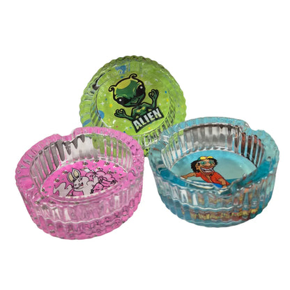 Three transparent-colourful ashtray bowls with cartoon designs on a white background
