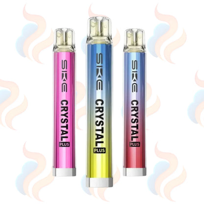 Three SKE Crystal Plus vape devices in pink, blue, and red on a white background with UK Vape Supply Logo