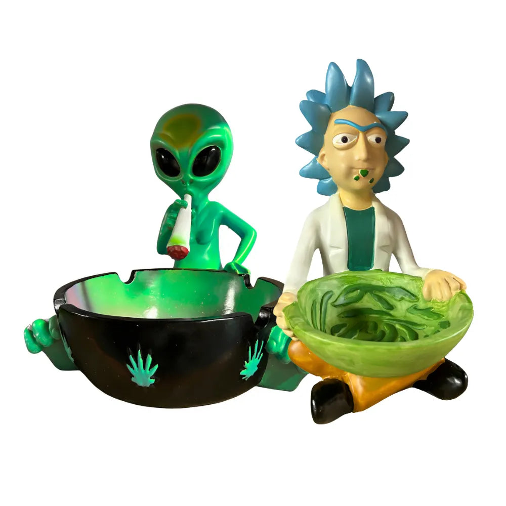 Two figurines ashtrays, one green alien and one with blue hair, holding bowls on a white background.