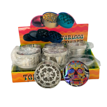 Tobacco grinders with colorful skull design on a display box.