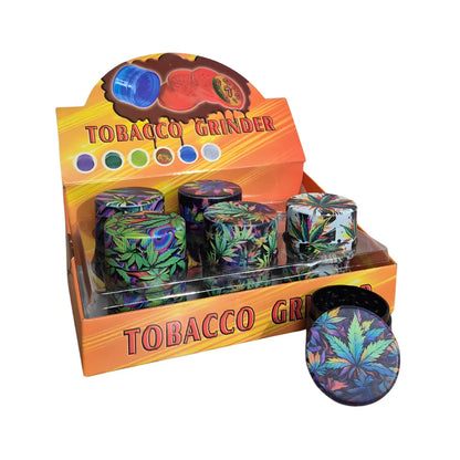 Display box of tobacco grinders with colorful designs on a white background